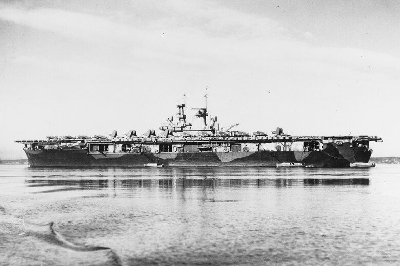 File photo of USS Wasp (CV 7) in Casco Bay, Maine, circa early 1942, with SB2U and F4F aircraft on her flight deck. Wasp is painted in a Measure 12 (Modified) camouflage pattern.