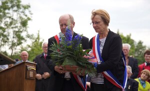 The Mayor of Amfreville lays a wreath during a ceremony in Amfreville, France