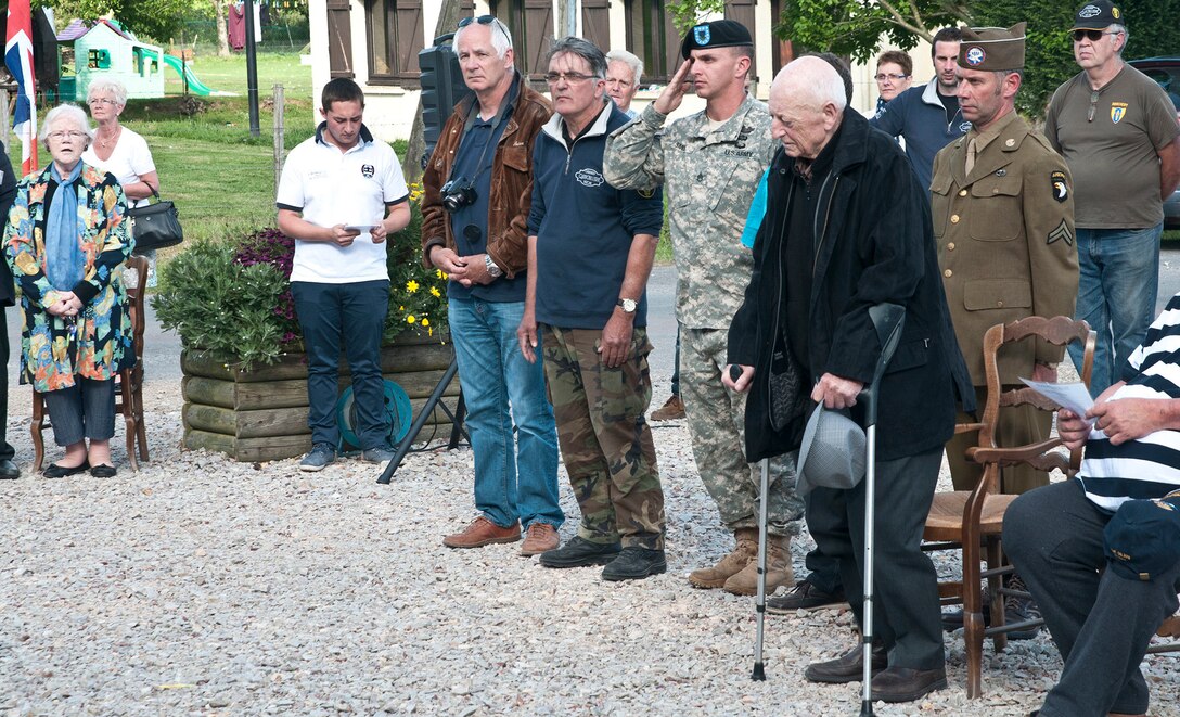 A Soldier salutes at a memorial service in Beuzeville-Au-Plain, France