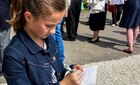 A local student draws a picture of U.S. Army Europe’s unit patch in Tournieres, France