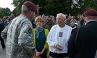 U.S. Army veteran Sgt. 1st Class Richard Yates speaks with Brig. Gen. Brian Winski in Gourbesville, France