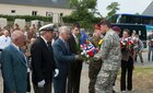 Sgt. Tim Carpenter hands flowers to a French civilian in Gourbesville, France