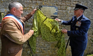 U.S. Air Force Brig. Gen. Patrick X. Mordente unveils a new plaque at a memorial in Coigny, France