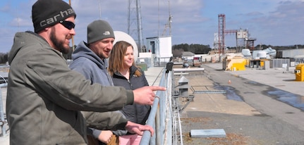 IMAGE: DAHLGREN, Va. (March 4, 2019) - Jennifer Ferrell - administrative lead for the Test and Evaluation Division at Naval Surface Warfare Center Dahlgren Division (NSWCDD) - looks out over the Potomac River Test Range (PRTR) as Chris Hayden, left, and Richard Lay explain their responsibilities as PRTR gun captains - to maintain, sustain, and ensure the safe operation of all Gun Weapon Systems on the range. The gun captains are key members of the Range Safety Team during range test execution involving guns, electric weapons, and unmanned systems. "The faster we can get funds properly in place, the faster we can execute the technical work to get the products delivered to the warfighter," said Ferrell who is responsible for the financial and human resources actions and financial management of PRTR. "I find pride in knowing that even though my role is non-technical, I can still make an impact to our warfighters by promoting more efficient financial and human resources policies and processes."