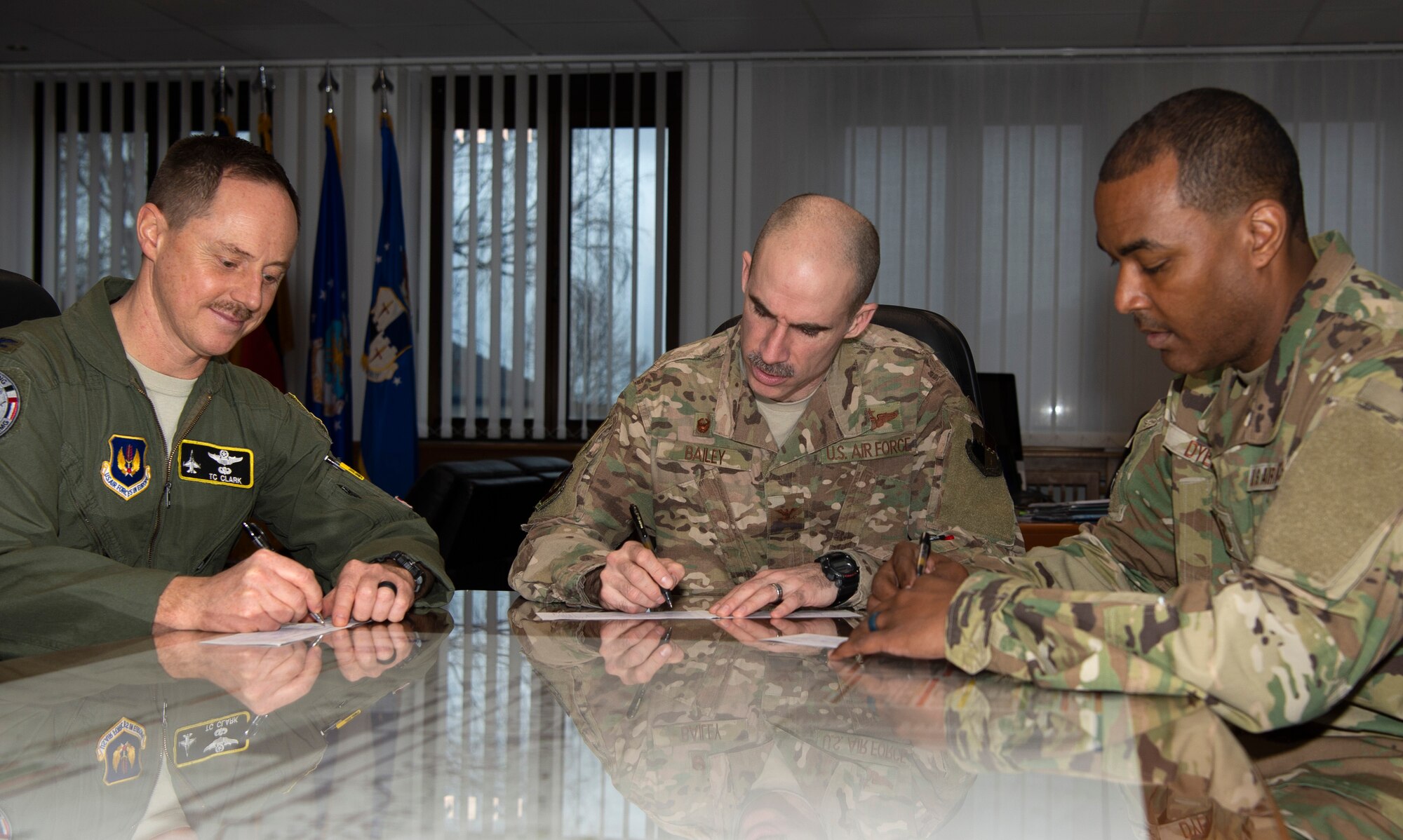 U.S. Air Force Col. Jason Bailey, 52nd Fighter Wing commander, center, Col. Tad Clark, 52nd FW vice commander, left, and Chief Master Sgt. Alvin Dyer, 52nd FW command chief, right, donate to the Air Force Assistance Fund at Spangdahlem Air Base, Germany, March 13, 2019. The AFAF includes four charities that provide support to Airmen and retiree's widowed spouses in need. (U.S. Air Force photo by Airman 1st Class Valerie Seelye)