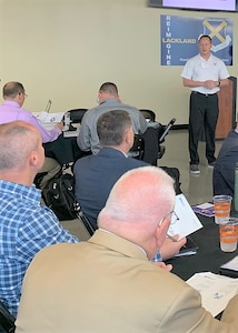 Military Training Instructor Senior Master Sgt. Jason Wagner (standing) facilitates the Professional DynaMetric Program Proscan assessment during the 37th Training Wing Senior Leader Conference held at the San Antonio, Texas, Alamodome Feb. 26 and 27. Wagner is one of a handful of MTIs who have recently completed certification on the PDP assessment, enabling them to help their San Antonio area teammates build stronger teams. (U.S. Air Force photo by Lt. Col. Christopher Victoria)