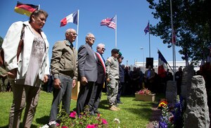 Representatives from America, France and Germany lay wreaths at a memorial in Chef Du Pont, France