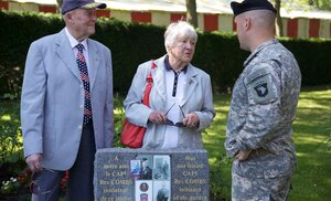 Lt. Col. Kurt Thompson of the 101st Airborne Division, speaks to a French couple in Chef-du-Pont, France