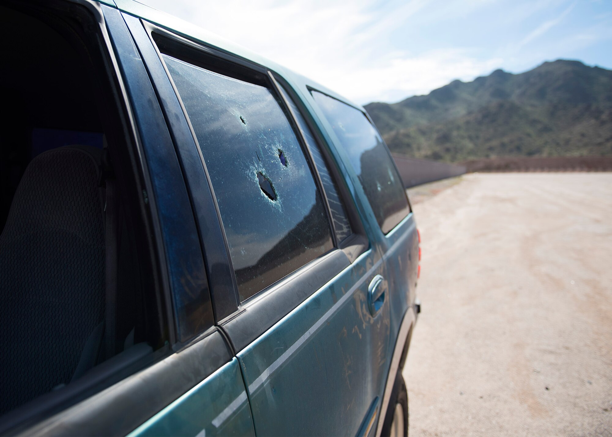 A bullet riddled vehicle serves as a target on the Maricopa County Sheriff’s Office Firing Range in Buckeye, Ariz., Feb. 25, 2019.