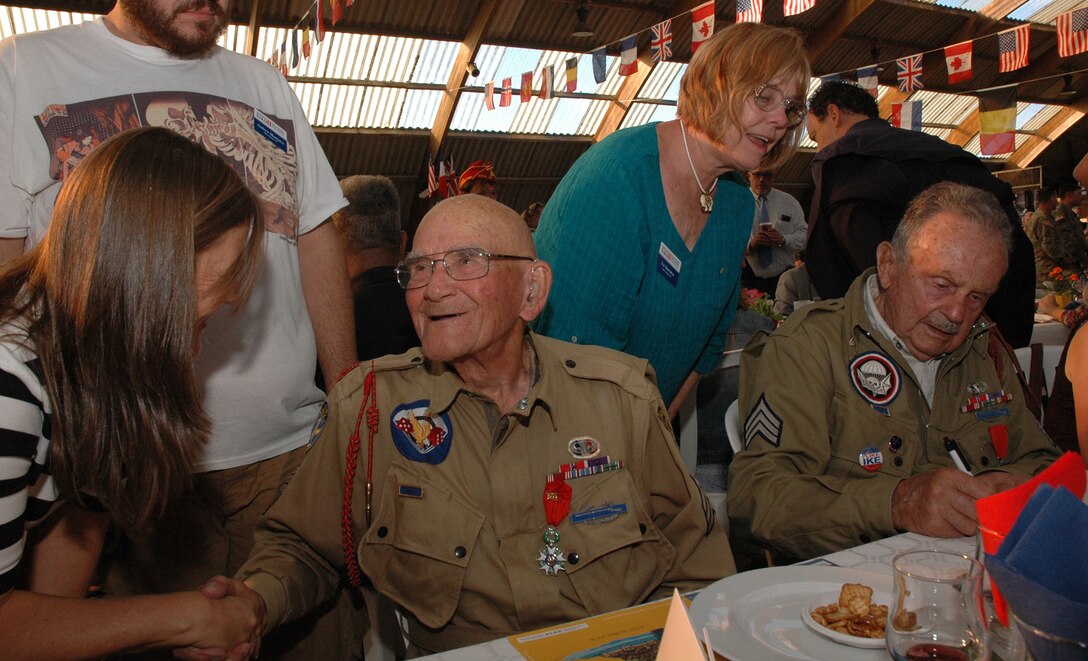 World War II veteran Bob Noody, left, and Dan McBride at the Liberation Dinner held in Sainte-Mère-Église, France