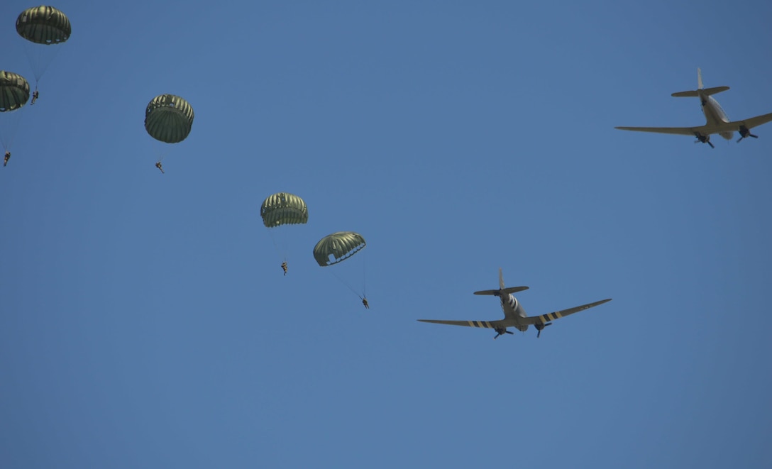25th Infantry Brigade Combat Team (Airborne) jump during a ceremony in Hemevez, France