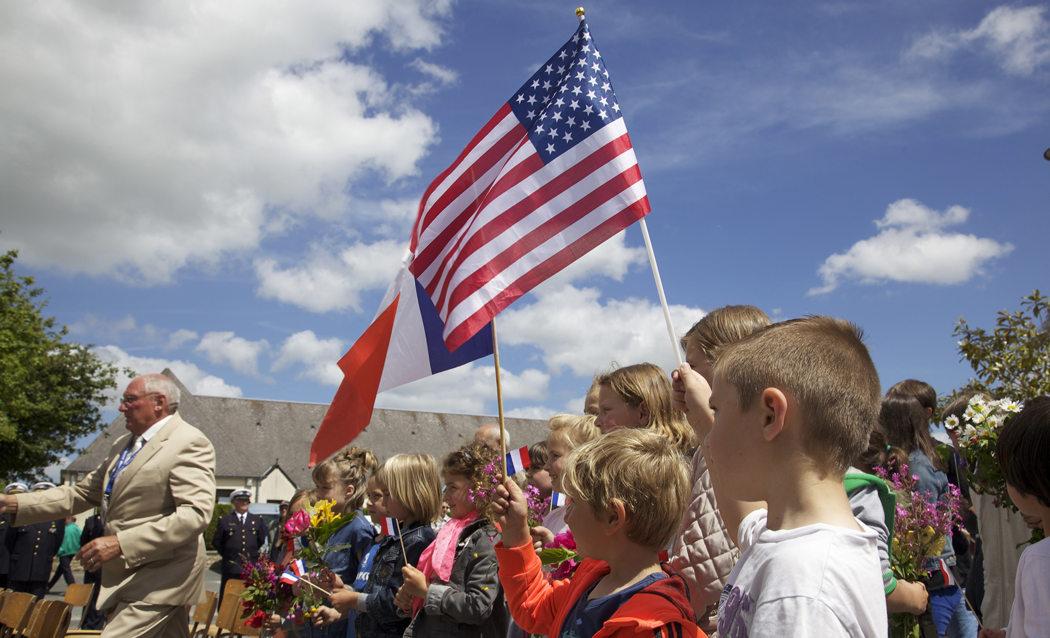 French School Children Wave American And French Flags During A Ceremony In Negreville France