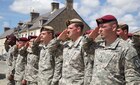 U.S. Army Soldiers salute during a ceremony in Negreville, France