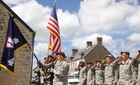 U.S. Army Soldiers salute during a ceremony in Negreville, France