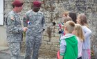 U.S. Army Soldiers talk to French School children after a ceremony in Negreville, France