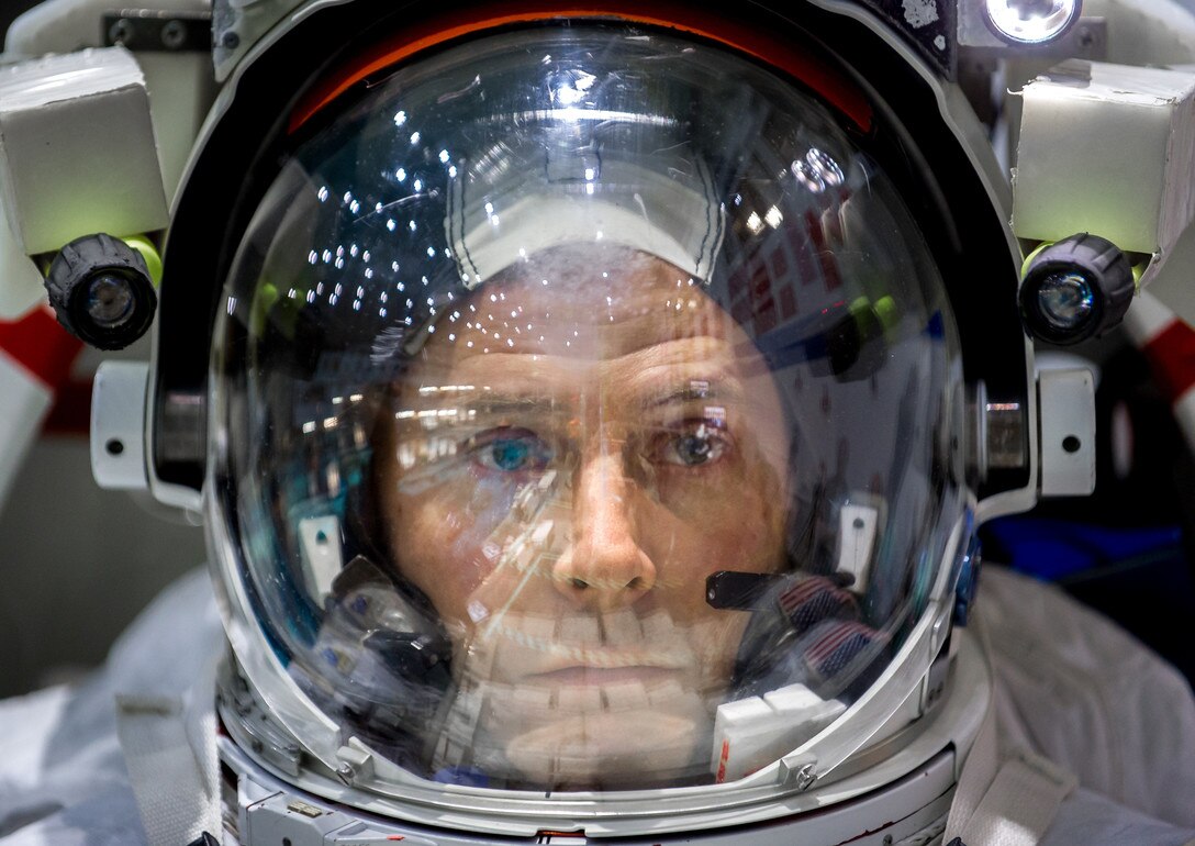 Col. Tyler N. Hague, a NASA astronaut, waits to be lowered into the pool containing a mock-up of the International Space Station at the Johnson Space Flight Center's Neutral Buoyancy Laboratory for Extravehicular Activity training in Houston, Texas, April 27, 2017. (U.S. Air Force photo by J.M. Eddins Jr.)