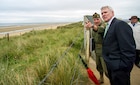 Secretary of the U.S. Navy Ray Mabus looks down Utah Beach in Sainte-Marie-du-Mont, France