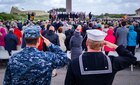 U.S. Navy Sailors salute during a ceremony in Sainte-Marie-du-Mont, France