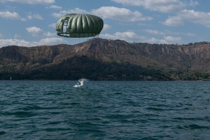 A service member lands into Lake Ilopango, El Salvador, after parachuting down from a UH-60 Blackhawk, March 5, 2019.