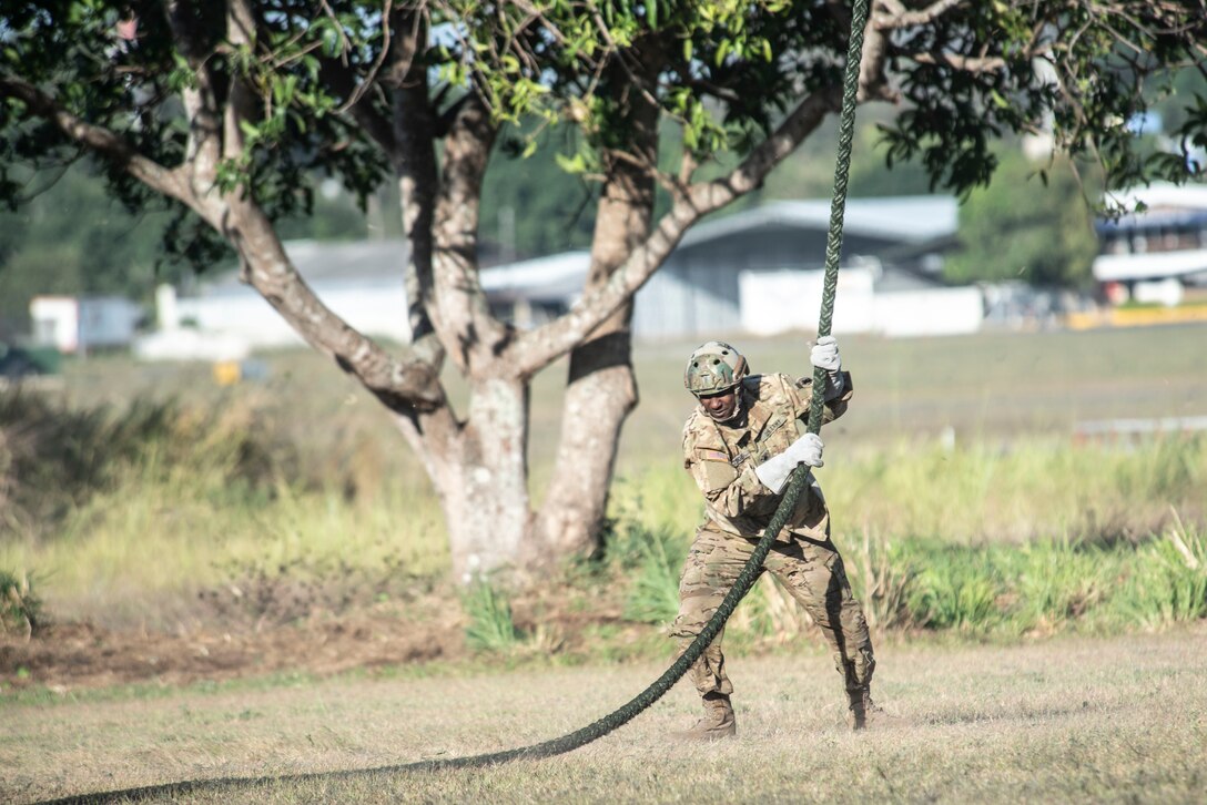 A U.S. Soldier lands on the ground after sliding down a rope from a UH-60 Blackhawk in Ilopango, El Salvador, March 6, 2019.