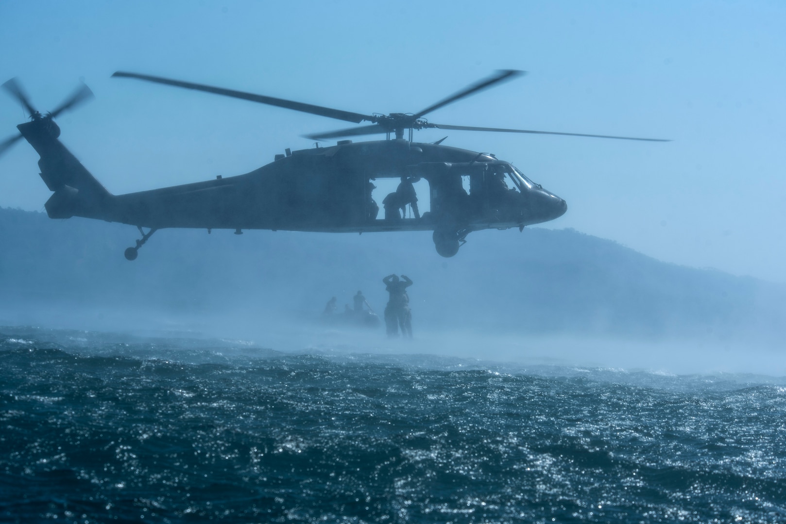 Service members practice helocasting by jumping into a lake from a UH-60 Blackhawk at Lake Ilopango, El Salvador, March 7, 2019.