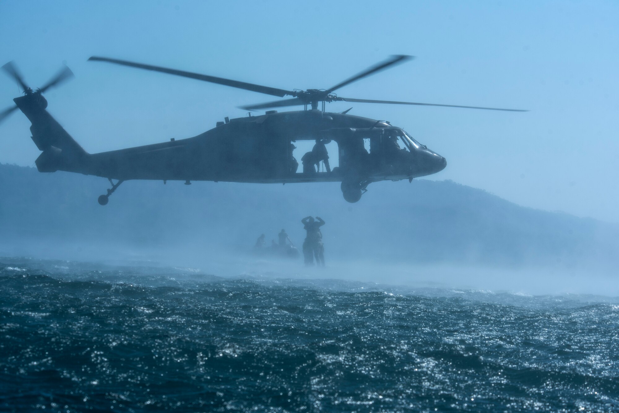Service members practice helocasting by jumping into a lake from a UH-60 Blackhawk at Lake Ilopango, El Salvador, March 7, 2019.