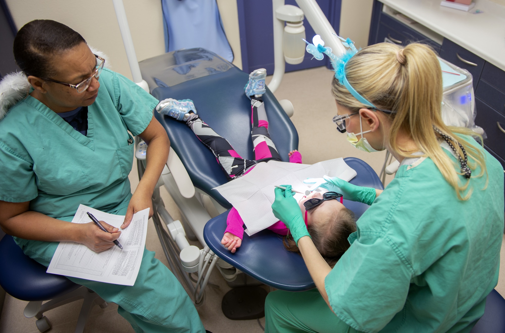 A child receives dental treatment during the “Give Kids a Smile” day event March 9, 2019, held by the 375th Dental Squadron clinic on Scott Air Force Base, Illinois.  Children registered for the event were given the chance to receive cleanings, fillings, and more to at no cost to their parents.  (U.S. Air Force photo by Airman 1st Class Isaiah Gonzalez)