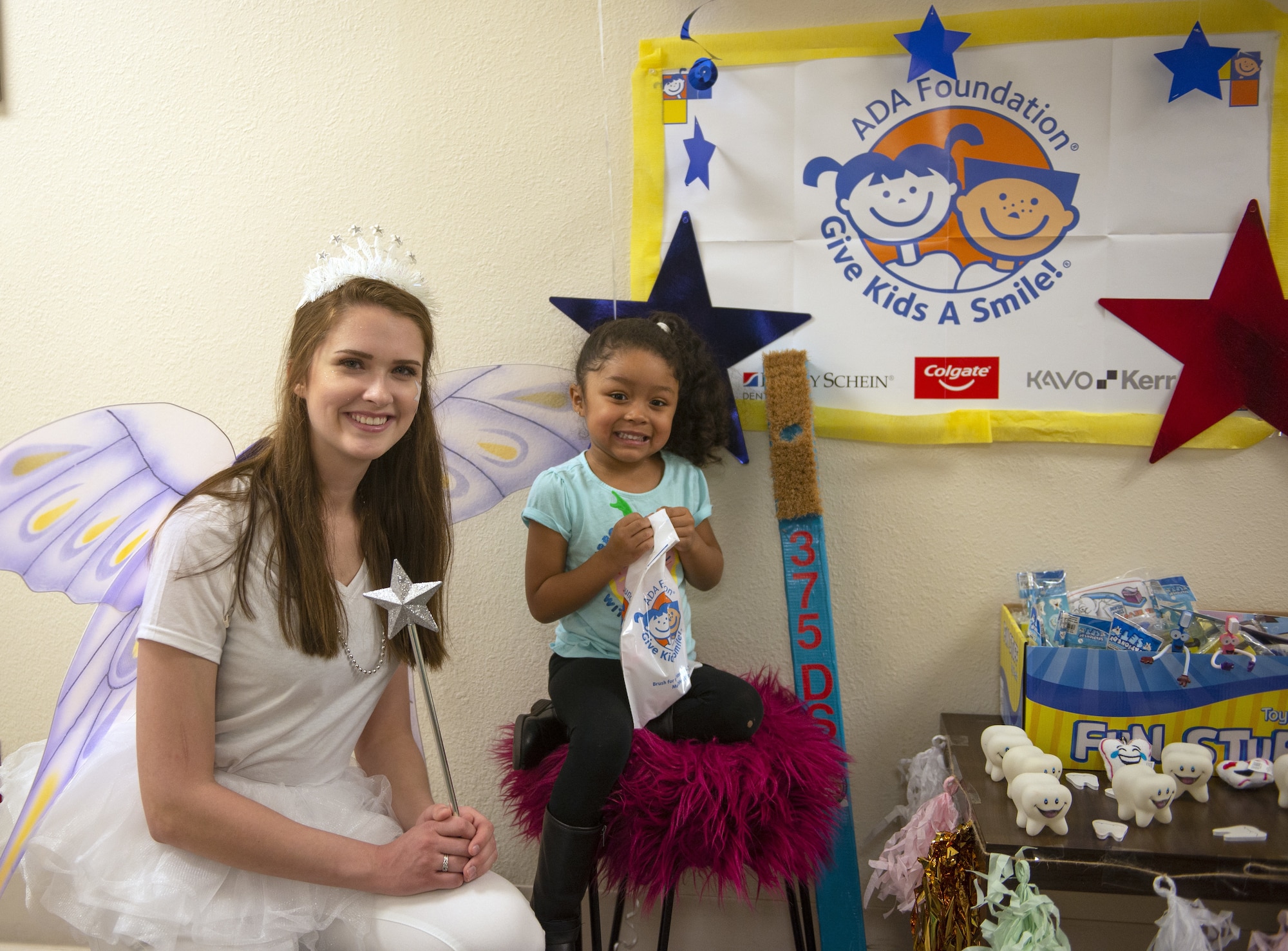Airman Shaina Nehs, 375th Dental Squadron dental assistant, volunteered to dress up as the “tooth fairy” to provide friendly encouragement to the visiting children before, during, and after their treatment. (U.S. Air Force photo by Airman 1st Class Isaiah Gonzalez)