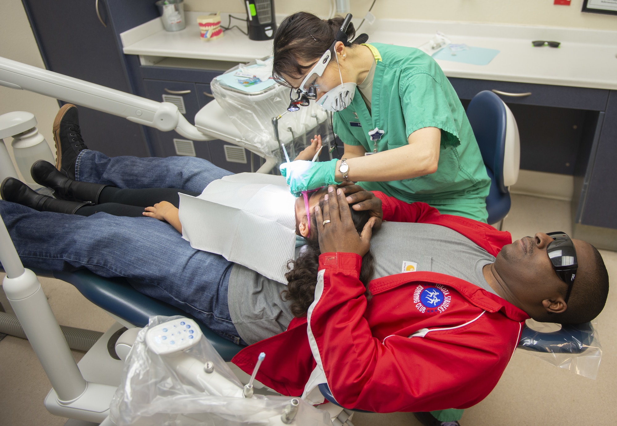 A child receives dental treatment during the “Give Kids a Smile” day event March 9, 2019, held by the 375th Dental Squadron clinic on Scott Air Force Base, Illinois.  Children registered for the event were given the chance to receive cleanings, fillings, and more to at no cost to their parents.  (U.S. Air Force photo by Airman 1st Class Isaiah Gonzalez)