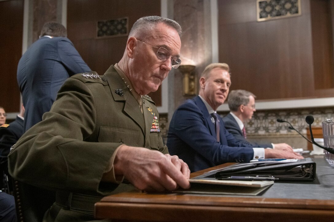 Marine Corps Gen. Joe Dunford, Acting Defense Secretary Patrick M. Shanahan and David L. Norquist sit at a table.