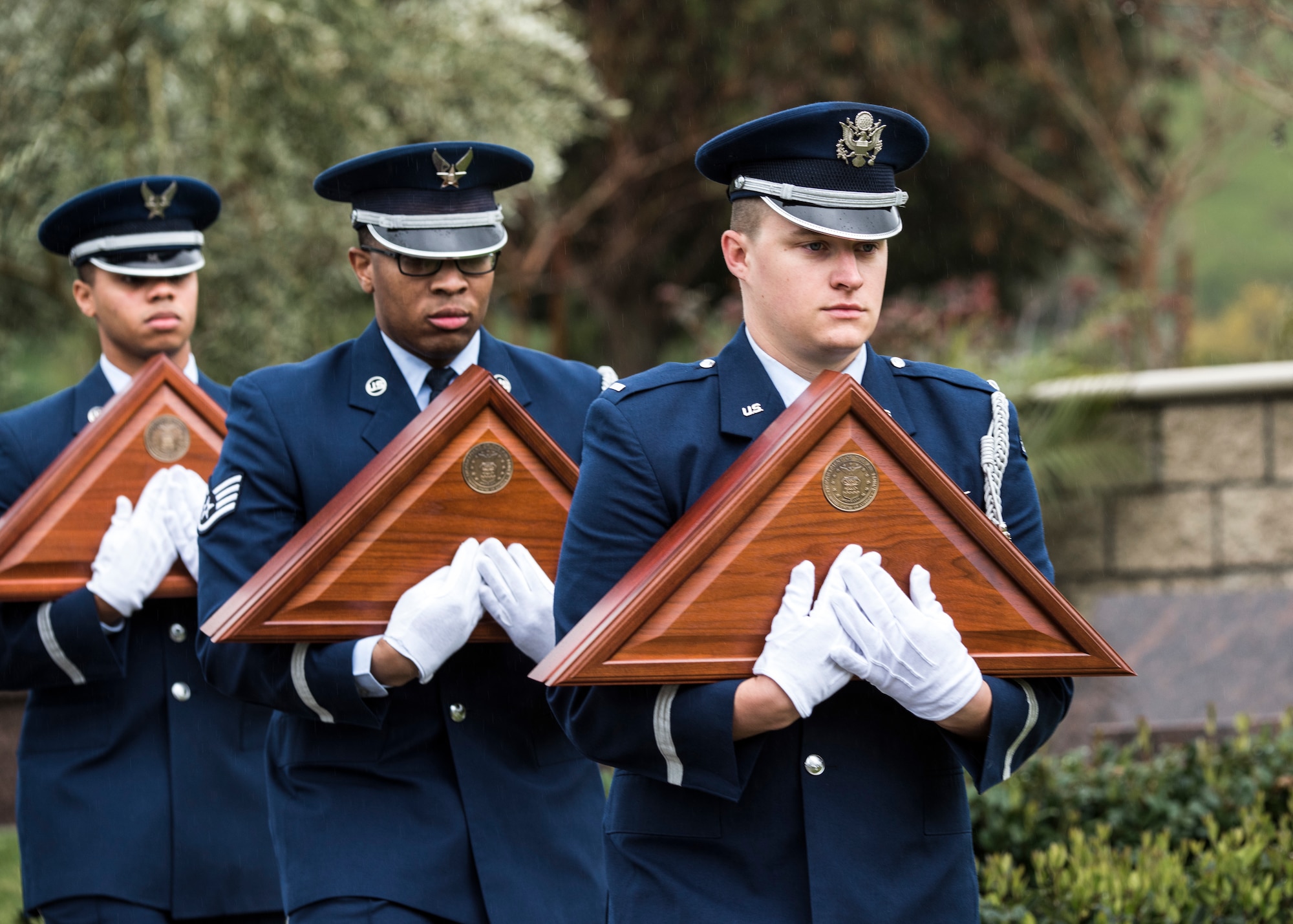 Vandenberg Honor Guard ceremonial guardsmen present flags to family members during a U.S. Air Force active duty funeral March 2, 2019 in Camarillo, Calif. Honor Guardsmen have many duties throughout a ceremony, one of which is to present the first-of-kin with a flag to honor their fallen loved one. (U.S. Air Force photo by Airman 1st Class Aubree Milks)