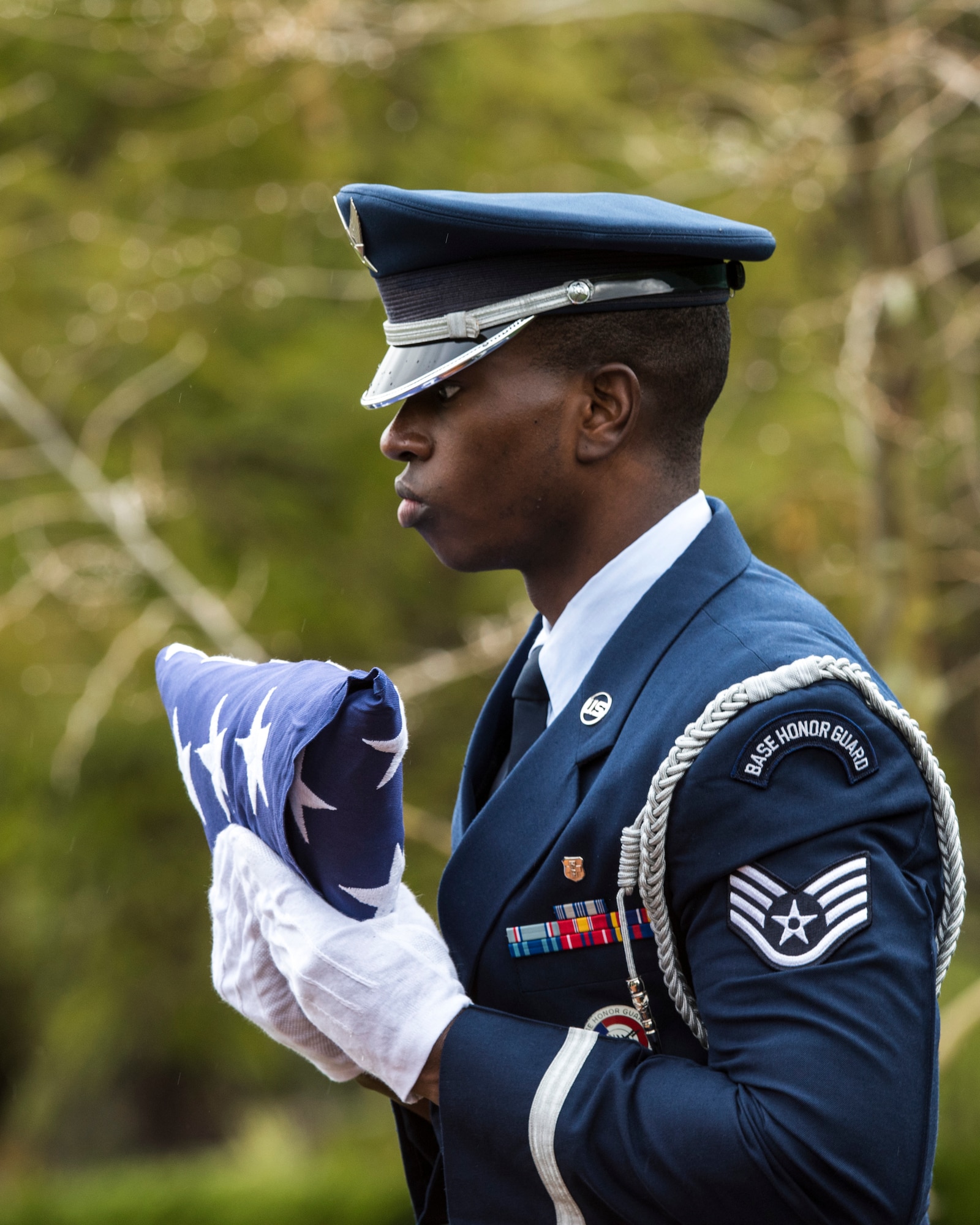 Staff Sgt. Marcus Hardy, Vandenberg Honor Guard flight chief and lead trainer, prepares to pass the flag to the next-of-kin during a U.S. Air Force active duty funeral March 2, 2019, in Camarillo, Calif. During a military funeral, guardsmen have the opportunity to either present the colors, be a member of the firing team or carry the casket with a flag draping over the fallen veteran. (U.S. Air Force photo by Airman 1st Class Aubree Milks)