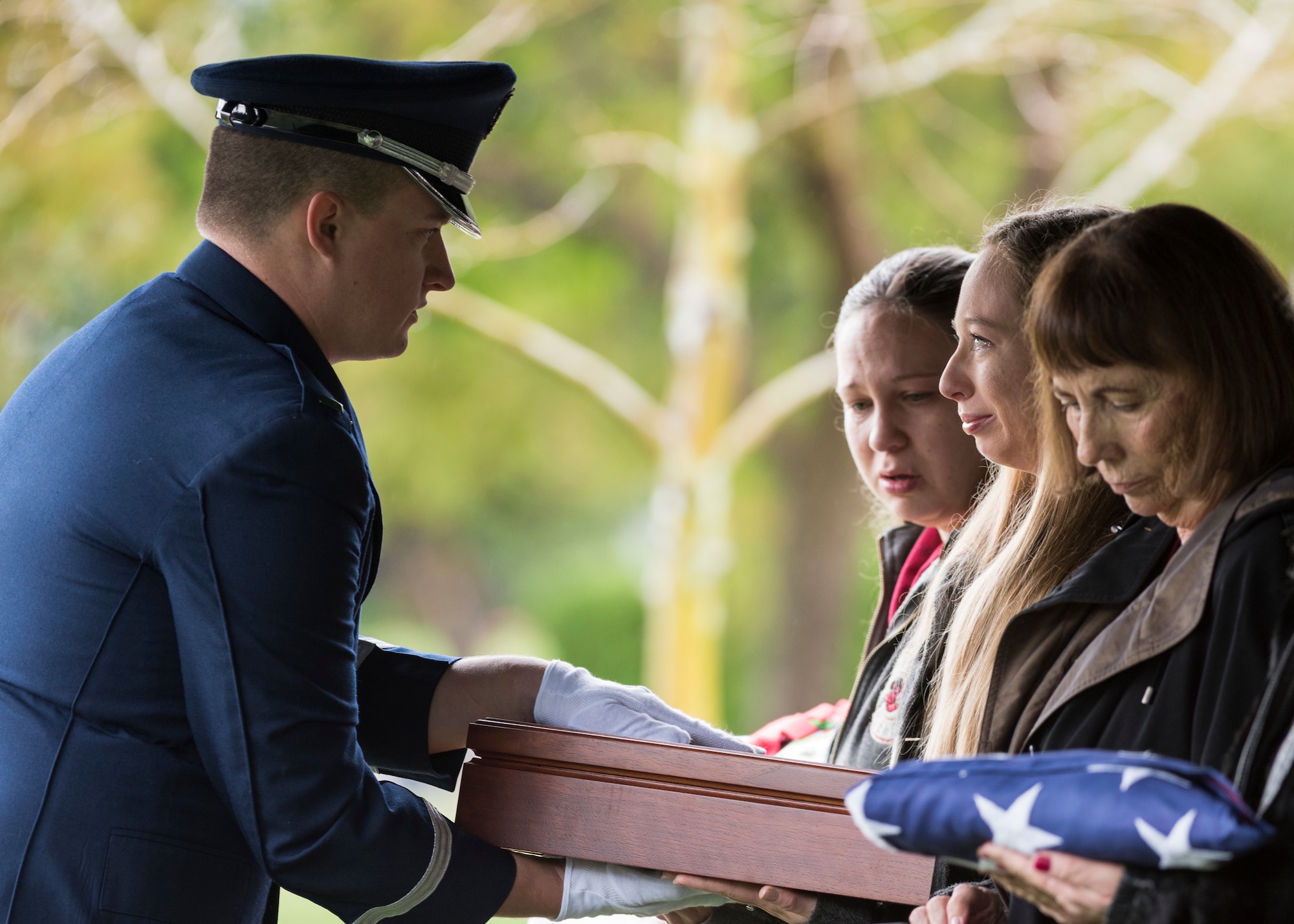 1st Lt. Andrew Forsythe, Honor Guard officer in charge, presents a flag to a family member of the deceased during a U.S. Air Force active duty funeral March 2, 2019, in Camarillo, Calif. According to the United States Department of Veteran Affairs, a military burial flag is provided to a deceased veteran in order to honor the memory of his service to the country. (U.S. Air Force photo by Airman 1st Class Aubree Milks)