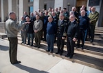 An American military officer speaks to military officers from NATO nations.