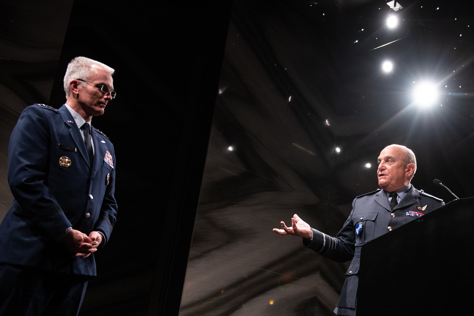 A British military officer gestures to an American military officer.