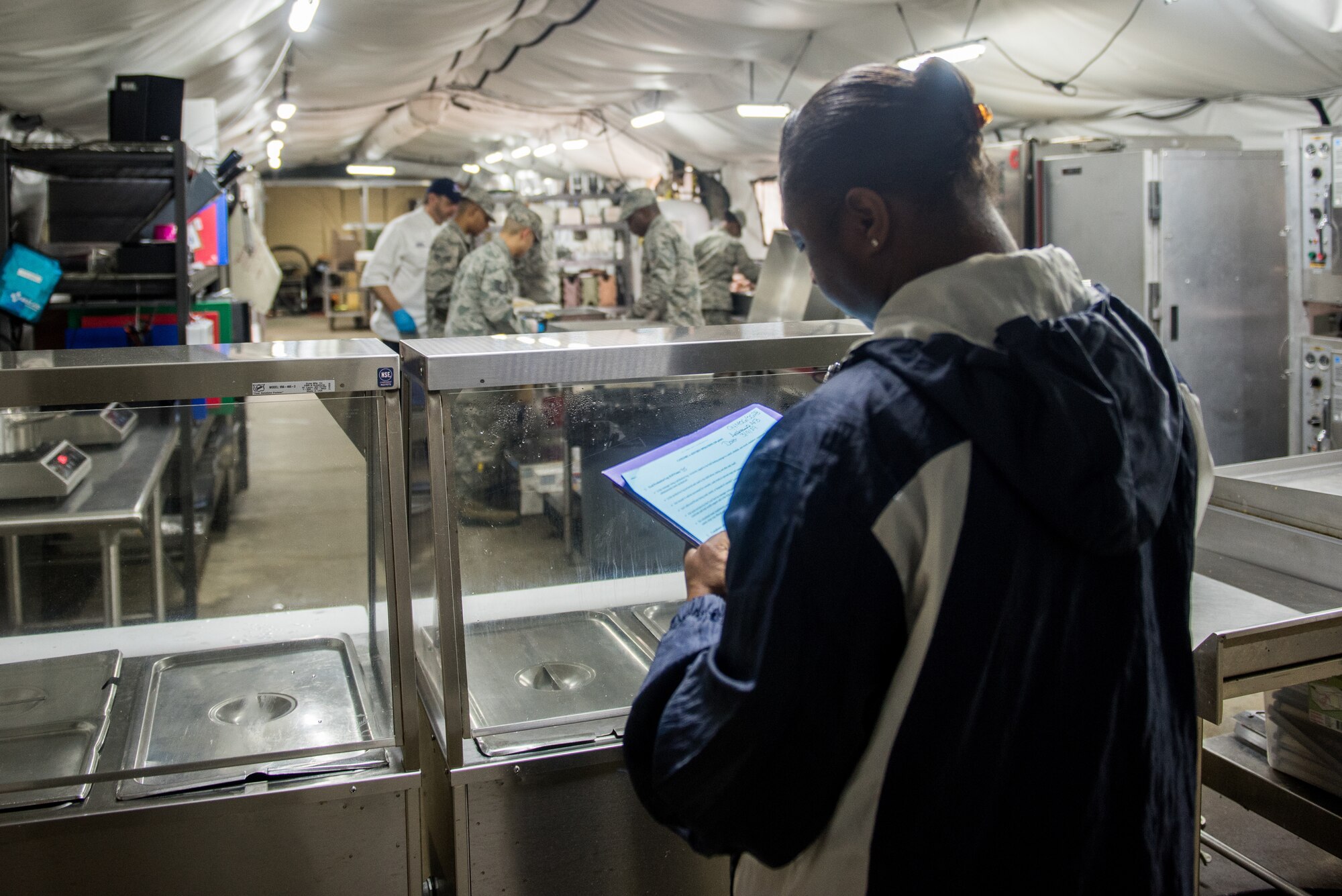 Pauletta Thompson, 94th Airlift Wing bioenvironmental engineer, evaluates the 512th Memorial Affairs Squadron cooking team at Dobbins Air Reserve Base, Georgia, March 9, 2019. The 512th MAS cooking team were evaluated on excellence in management, force readiness support, food quality and production, and safety awareness. (U.S. Air Force photo by Staff Sgt. Damien Taylor)