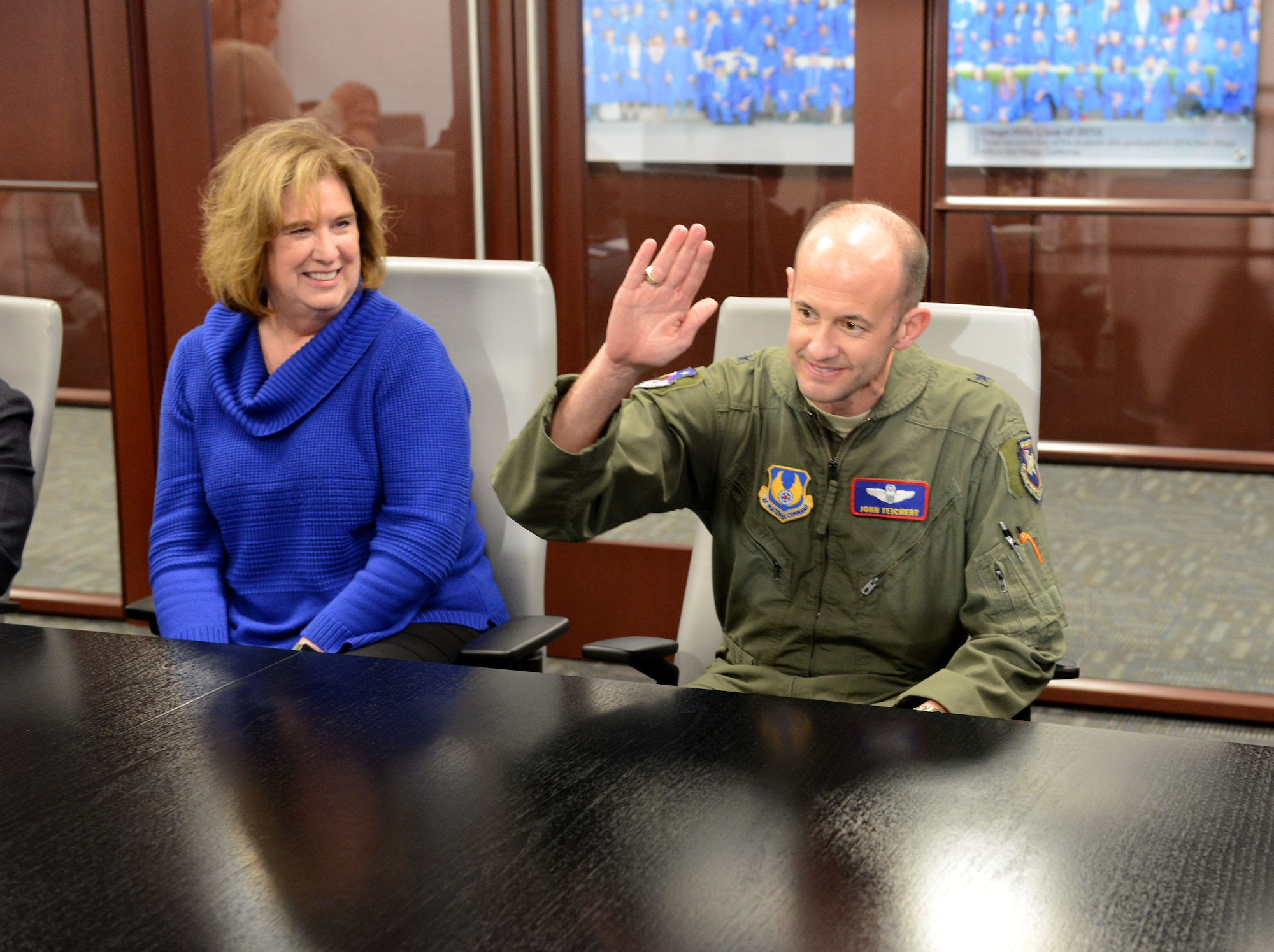Brig. Gen. E. John Teichert, 412th Test Wing commander, raises his hand to "slap the table" to symbolically solidify a formal multi-year partnership to conduct alternating air shows within the region at the Learn4Life meeting room in Lancaster, California, March 13. This paves the way to resume air shows at Edwards Air Force Base, the new schedule will bring a “double header” air show year for the region, with air shows scheduled for March 2020 at General
William J. Fox Air Field in Lancaster and October 2020 at Edwards Air Force Base. After 2020, the air shows will alternate with Edwards’ as the venue on even years, and Fox Field hosting on odd years. (U.S. Air Force photo by Michelle
Thomas)