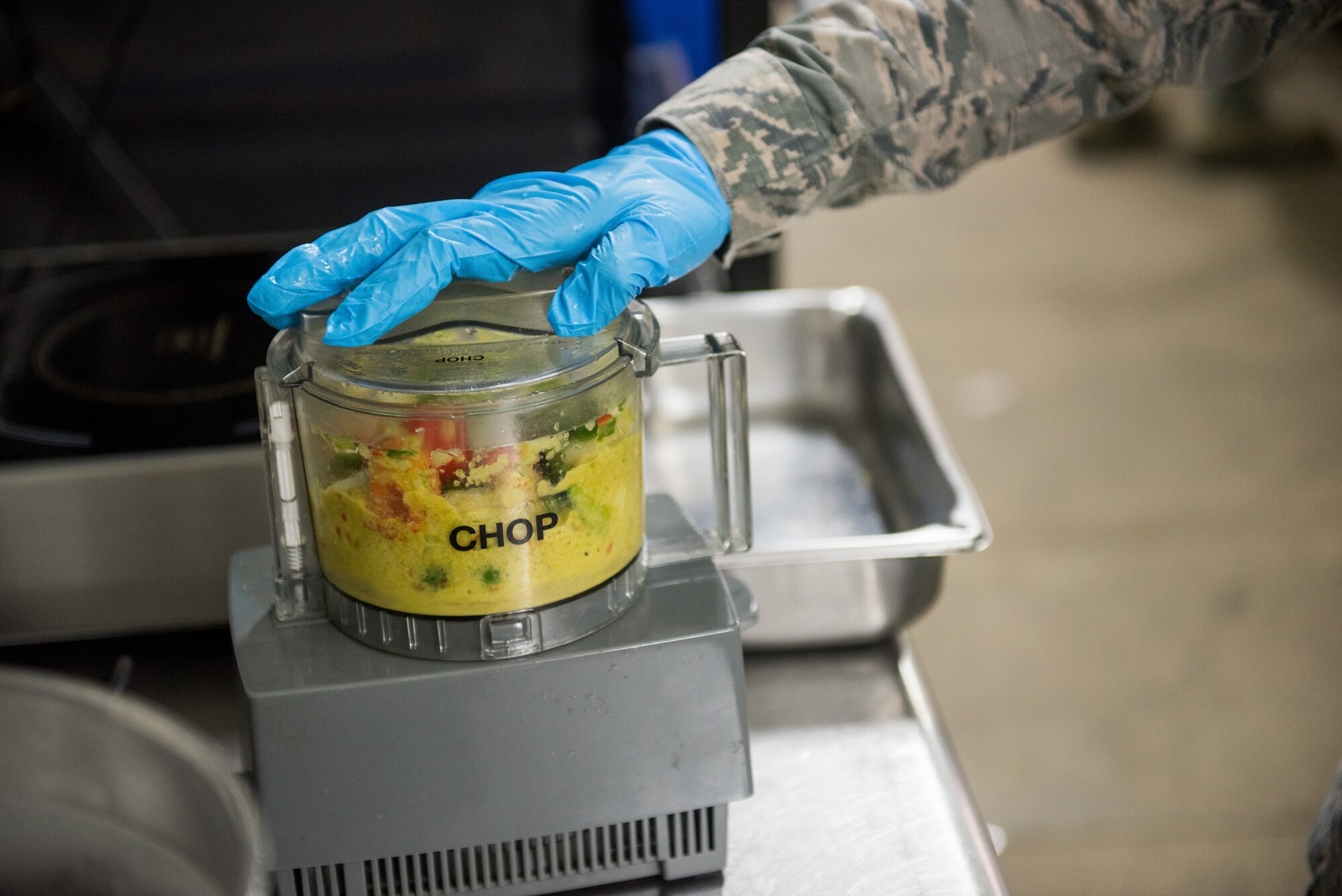 Senior Airman Samoya Nicholson, 512th Memorial Affairs food services shift supervisor, blends peppers and vegetables during the John L. Hennessy food service competition at Dobbins Air Reserve Base, Georgia, March 9, 2019. Four Air Force Reserve Command units competed on different dates utilizing the Dobbins ARB Silver Flag site kitchen to compete. (U.S. Air Force photo by Staff Sgt. Damien Taylor)