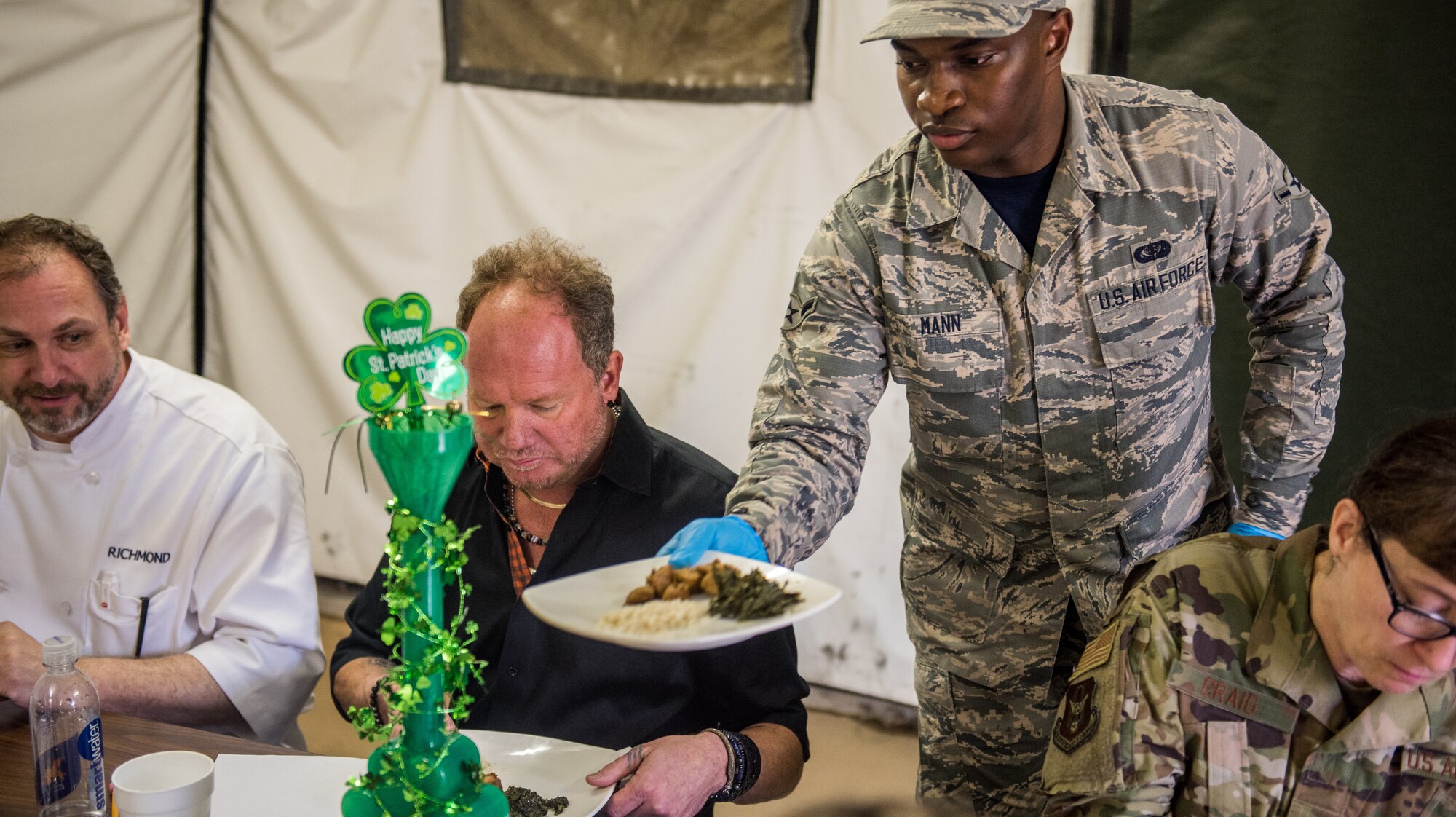 Airman Brandon Mann, 512th Memorial Affairs Squadron food specialist, serves an entrée to the judges during the John L. Hennessy food service competition, March 9, 2019. The 512th MAS cooking team won the Hennessy award in 2017. (U.S. Air Force photo by Staff Sgt. Damien Taylor)