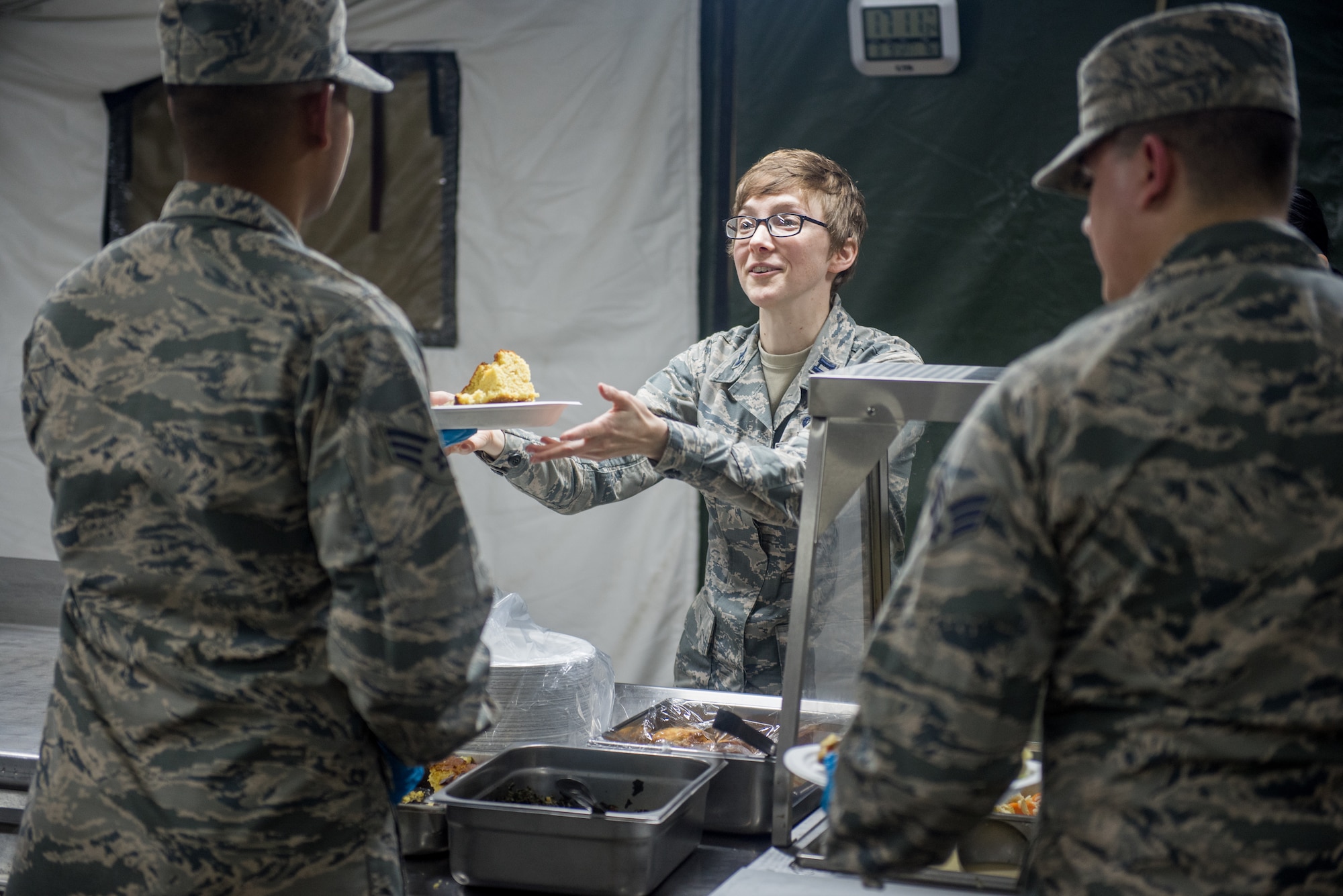 Senior Airman Ryan O’Brien, 512th Memorial Affairs food specialist, and Senior Airman Bryan Seijo, 512th MAS lodging specialist, serve meals to trainees at Dobbins Air Reserve Base, Georgia, March 9, 2019. The 512th MAS cooking team was evaluated on employee and customer relations. (U.S. Air Force photo by Staff Sgt. Damien Taylor)