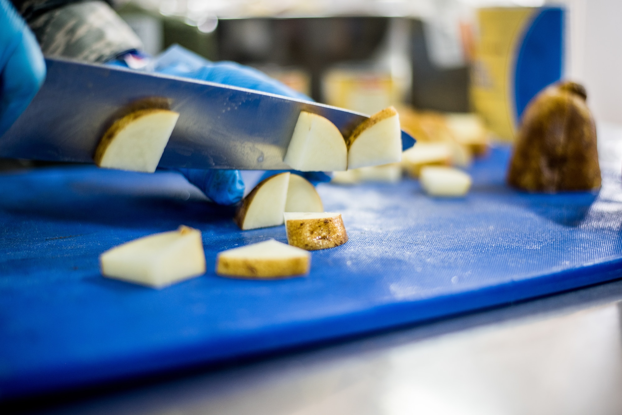 Senior Airman Bryan Seijo, 512th Memorial Affairs Squadron lodging specialist, slices potatoes during the John L. Hennessy food service competition at Dobbins Air Reserve Base, Georgia, March 9, 2019. The 2019 Hennessy food service competition focused on the competing units’ culinary arts capabilities. (U.S. Air Force photo by Staff Sgt. Damien Taylor)