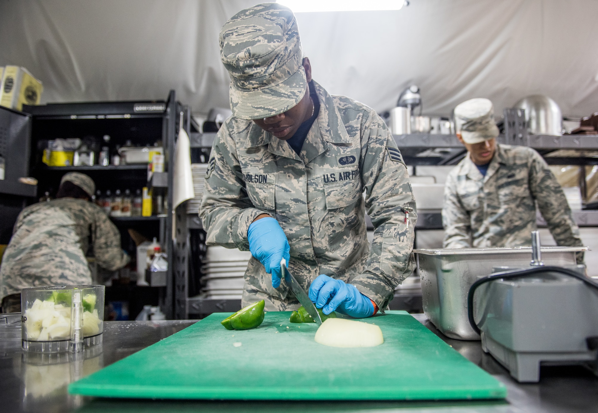 Senior Airman Samoya Nicholson, 512th Memorial Affairs food services shift supervisor, slices a pepper during the John L. Hennessy food service competition at Dobbins Air Reserve Base, Georgia, March 9, 2019. The 2019 John L. Hennessy food service competition was held at Dobbins ARB’s Silver Flag site. (U.S. Air Force photo by Staff Sgt. Damien Taylor)