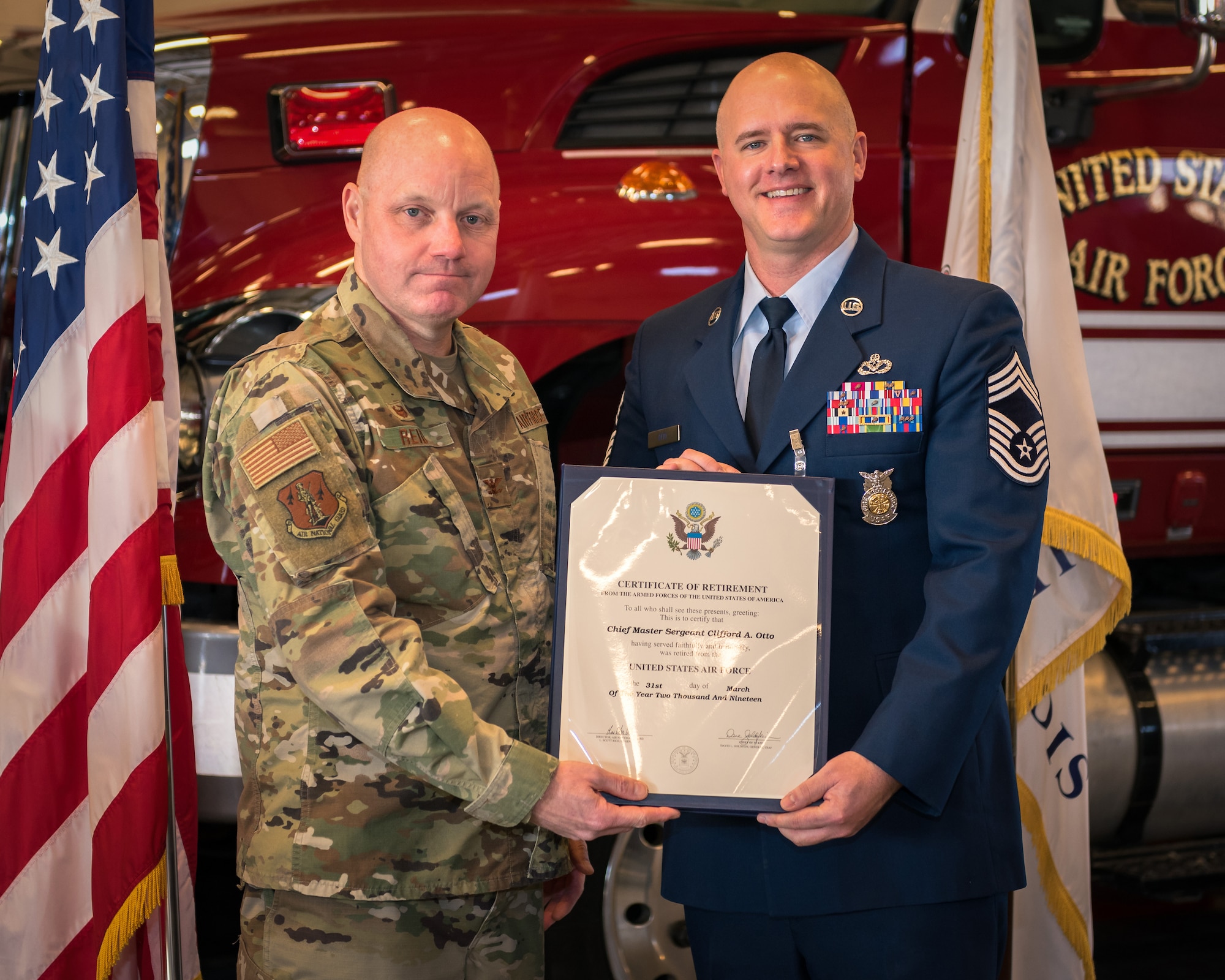 Col. Reid gives Chief Otto his retirement certificate.