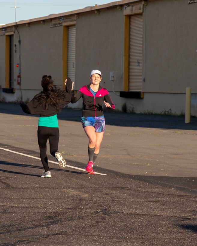Ruth Clemans and Rose Schwartz high five each other as they finish their daily training aboard Marine Corps Logistics Base Barstow, California, for upcoming marathons, March 7. Schwartz will be racing in the LA Marathon to be held in March and Clemans will be racing in the Duluth Marathon in June, where she plans to qualify for the Boston Marathon 2020.