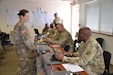 Capt. Beth Appleman, logistics support officer with 1st Logistics Civil Augmentation Program Support Battalion, takes a moment to discuss the importance of understanding the area of operations and requests from the requiring activity