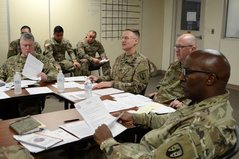 The MOC Joint Readiness Review Board analyzes a team’s statement of work and letter of justification.  The culminating portion of the mobilization exercise was a simulated Joint Readiness Review Board where each team presented their statement of work and letter of justification before the commander, the command sergeant major, and the staff sections.