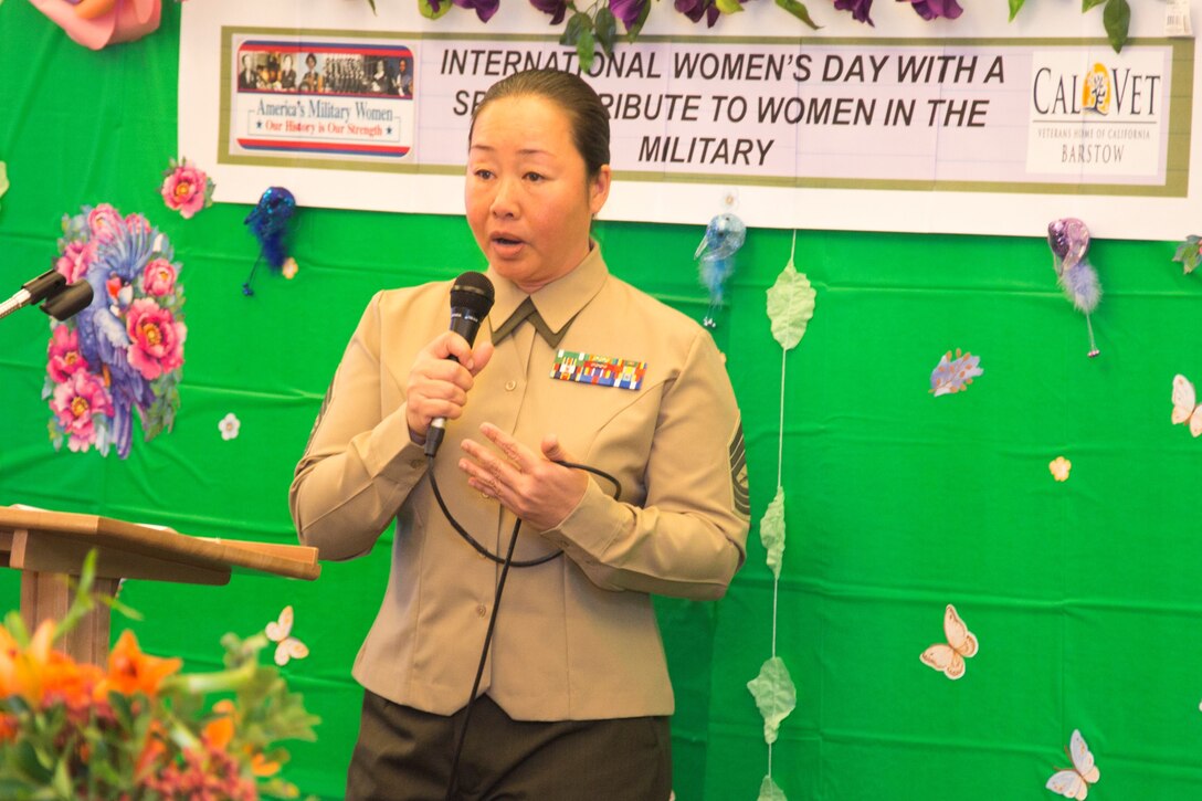Master Sergeant Tianna Tien, S6 communications chief, Marine Corps Logistics Base Barstow, Calif., talks to a packed room about her experience fleeing communist Vietnam after the fall of Saigon in 1975. She was invited to be the keynote speaker at the International Women's Day event, March 8.