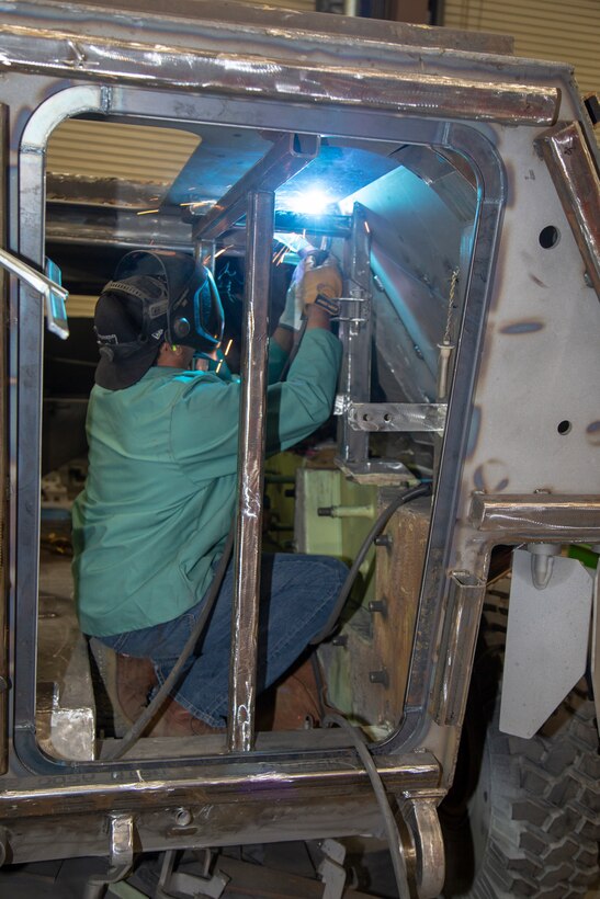 Welder Eugene Dunford uses an arc welder to adhere a piece of metal to a Light Armored Vehicle at the Weld Shop located within Production Plant Barstow, Marine Depot Maintenance Command, on the Yermo Annex aboard Marine Corps Logistics Base Barstow, Calif., March 13. The Weld Shop crew works on hundreds of pieces of Marine Corps equipment every year, ensuring that war fighters in theater have sound and effective equipment out in the field.