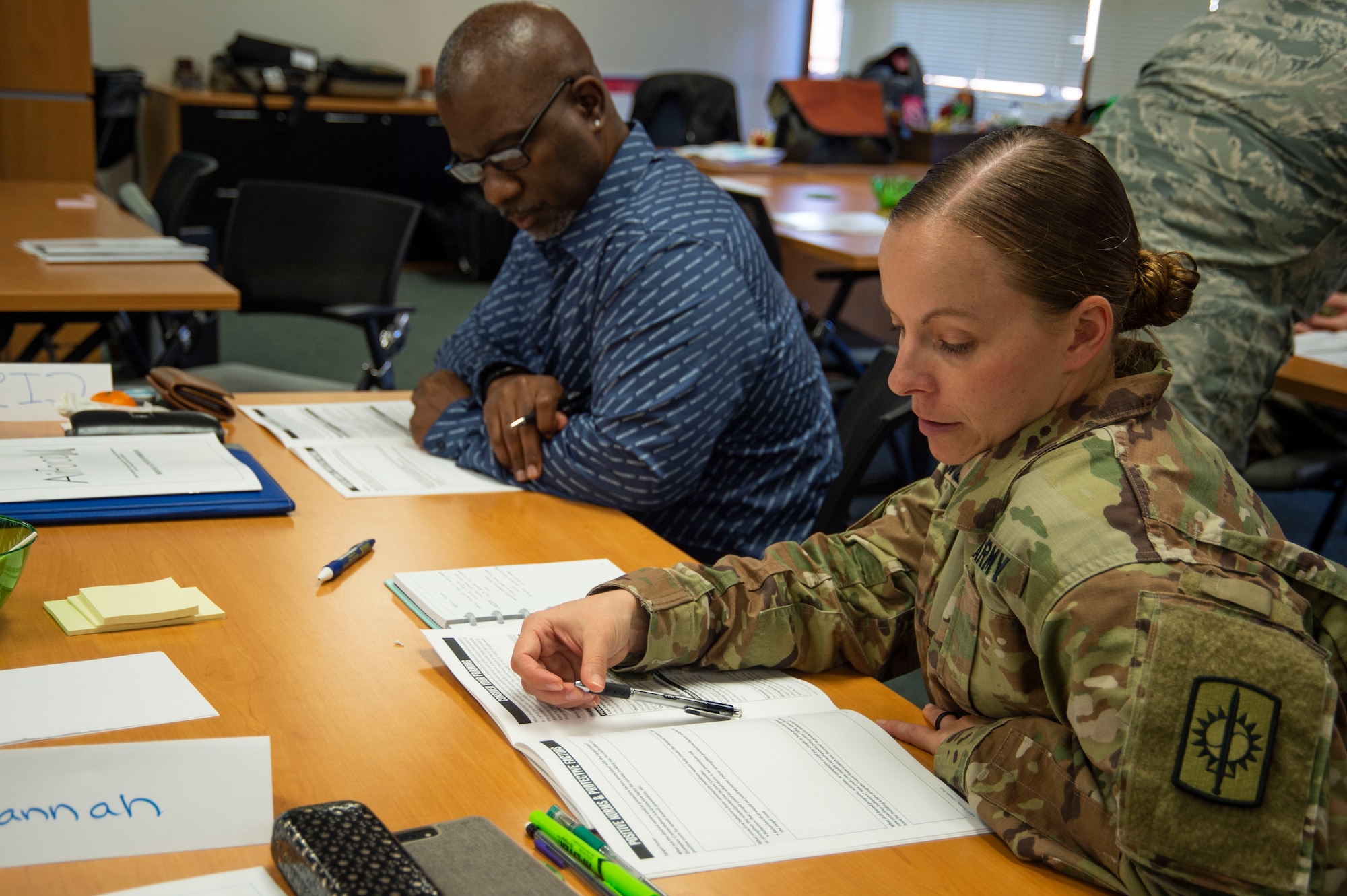 Cisco Johnson, 647th Force Support Squadron recovery care coordinator, and U.S. Amy Sgt. 1st Class Hannah Nunley, 728th Military Police Battalion sexual assault and response coordinator, work together on a prevention activity during the Green Dot Shift Happens workshop on Joint Base Pearl Harbor-Hickam, Hawaii, Mar. 13, 2019. Green Dot underwent a foundational shift from a focus on teaching members how to respond to a violent situation, to emphasizing cultural changes to prevent violent situations. (U.S. Air Force photo by Tech. Sgt. Heather Redman)