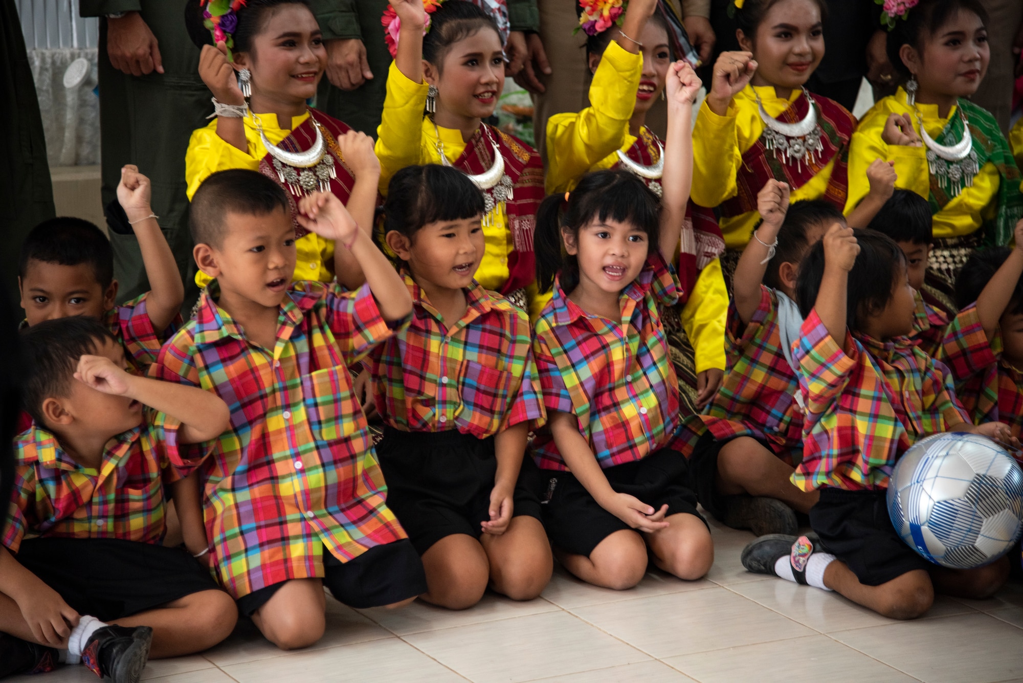 Ban PaLai School children cheer after receiving donations from the U.S., Royal Thai and Singaporean air forces during a COPE Tiger 2019 cultural exchange at Korat, Thailand, March 13, 2019.